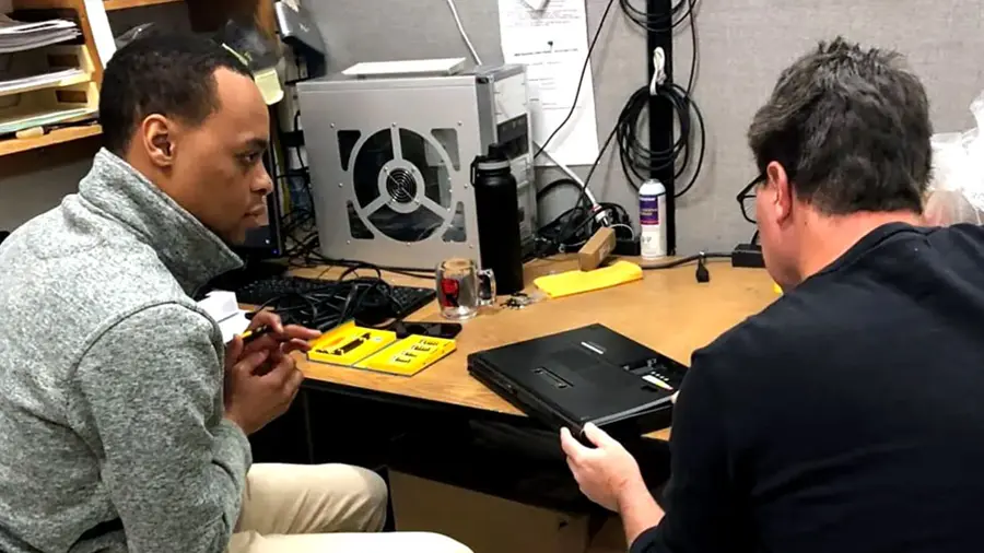 Collaborative troubleshooting—netEffx techs team up to repair a client’s laptop with precision and care.